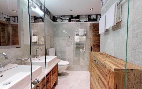 a bathroom with a sink and a toilet and a shower at Giant 7 in St. Moritz