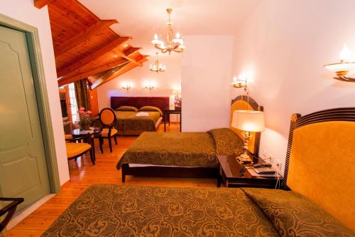 a room with two beds and a living room at Krikonis Hotel in Ioannina