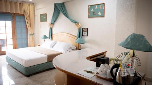 a hotel room with a bed and a desk with a desk at Clarkton Hotel Apartment in Angeles