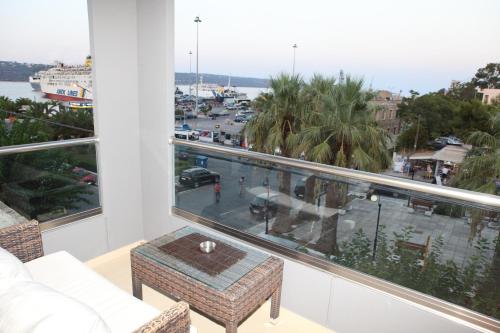 a living room with a view of a marina at Oneiro Suites in Souda