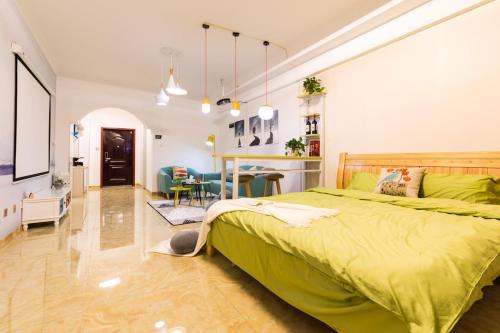 a bedroom with a green bed and a dining room at XiNing Chengxi ·Wanda square· in Xining