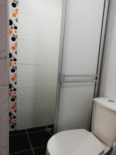 a bathroom with a toilet and a shower at APARTA ESTUDIO 7051 in Medellín