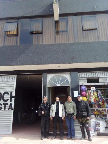 a group of men standing in front of a building at Hostal Inca in San Pedro