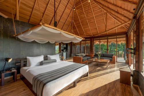 a bedroom with a bed and a living room at 98 Acres Resort & Spa in Ella