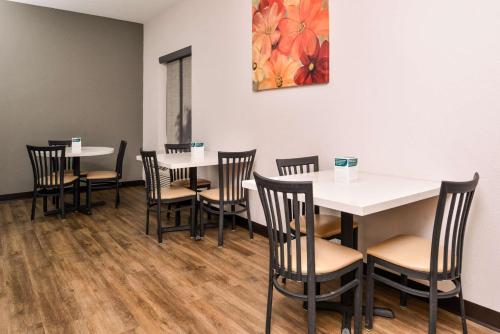 a dining room with white tables and chairs at Quality Inn Joplin I-44 in Joplin