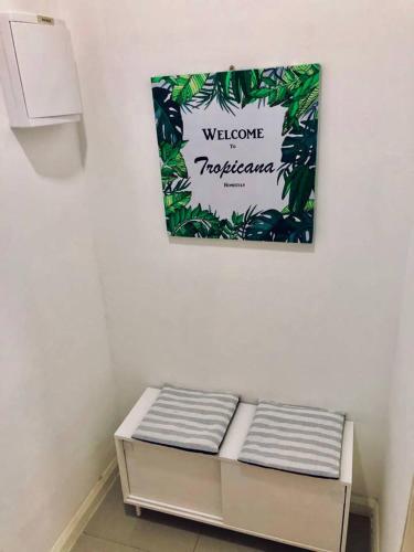 a sign hanging on a wall above a bench at D'pristine by Antlerzone in Johor Bahru