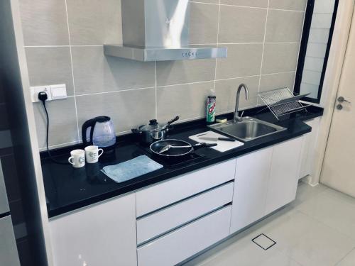 a kitchen with a sink and a counter top at D'pristine by Antlerzone in Johor Bahru