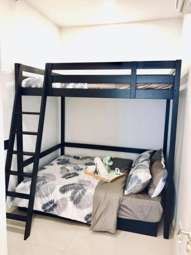 a bunk bed in a room with a ladder at D'pristine by Antlerzone in Johor Bahru