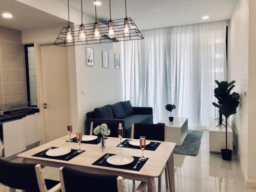 a living room with a table and a blue couch at D'pristine by Antlerzone in Johor Bahru