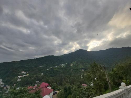 a view of a mountain under a cloudy sky at Goga Guest House in Kvariati