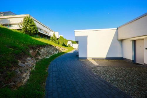 a walkway next to a building next to a building at Słoneczny Cypel in Gródek Nad Dunajcem