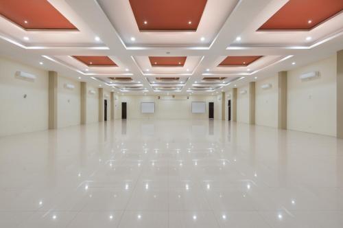 an empty hall with white floors and ceilings at Nava Hotel Tawangmangu in Tawangmangu
