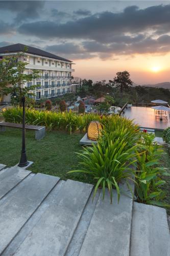 a hotel with a garden and a resort at Nava Hotel Tawangmangu in Tawangmangu