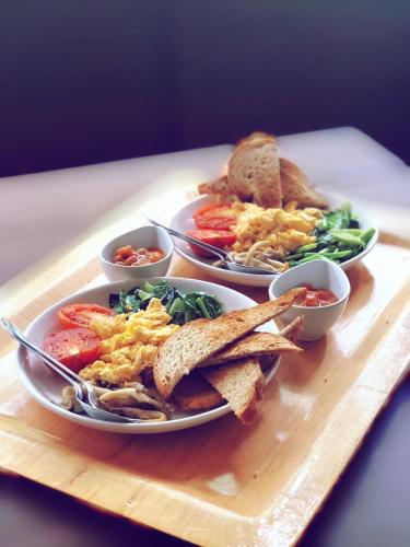 tres platos de comida en una bandeja de madera en Adang Sea Divers & Eco Lodge, en Ko Lipe