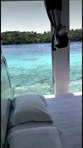 a view of the ocean from a window of a boat at Mr. Bean Resort in Sabong