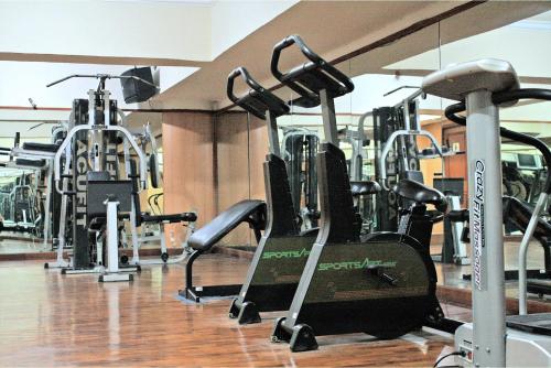 a gym with rows of treadmills and machines at Tunjungan Hotel in Surabaya