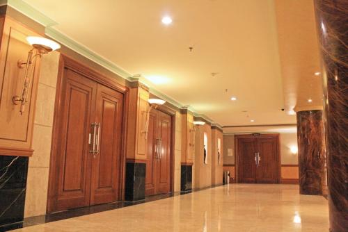 a large hallway with wooden cabinets in a building at Tunjungan Hotel in Surabaya