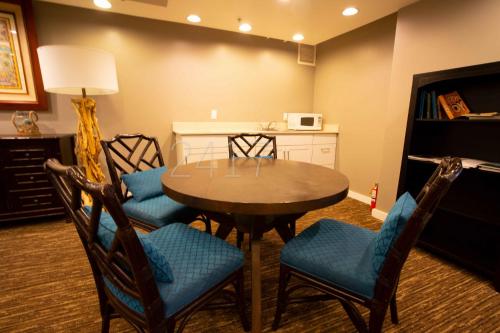 a dining room with a table and four chairs at 2417 at Oceanfront Resort Lihue Kauai Beach Drive Private Condo in Lihue
