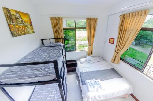 a small room with two bunk beds and a window at Poni Homestay in Bandar Seri Begawan