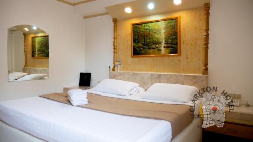two beds in a room with a mirror at Clarkton Hotel Apartment in Angeles
