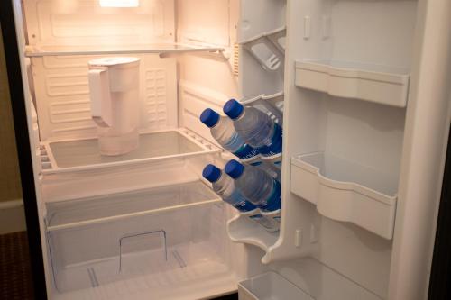 an open refrigerator with blue water bottles in it at 2417 at Oceanfront Resort Lihue Kauai Beach Drive Private Condo in Lihue