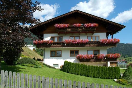 a house with flower boxes on top of it at Pension Bartlhof in Lermoos