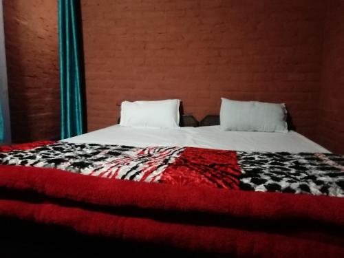 a bed with two pillows on top of it at Garhwal Resort, Raithal, Bhatwari, Uttarkashi in Uttarkāshi