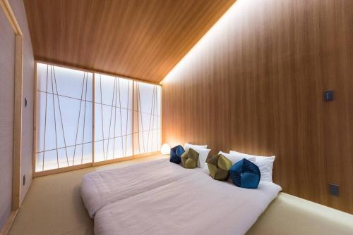 a large bed in a room with a large window at TABITABI STAY MOONLIGHT in Kyoto
