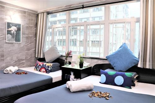 a room with two beds and a window at W's Lounge in Hong Kong