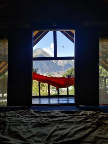 a bedroom with a window with a view of a mountain at Sembalun Kita Cottage in Sembalun Lawang