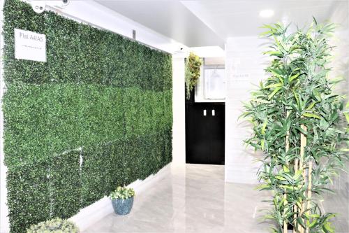 una pared verde en una habitación con plantas en W's Lounge en Hong Kong