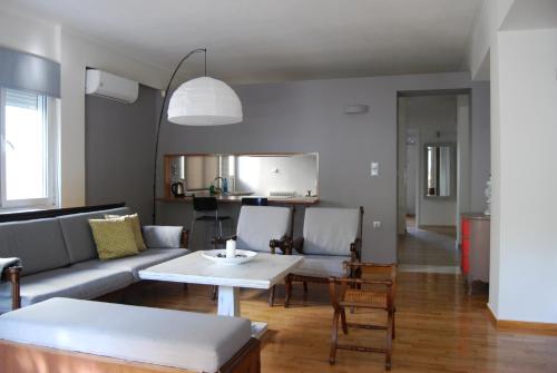 a living room with a couch and a table at Affordable luxury garden apartment in Athens