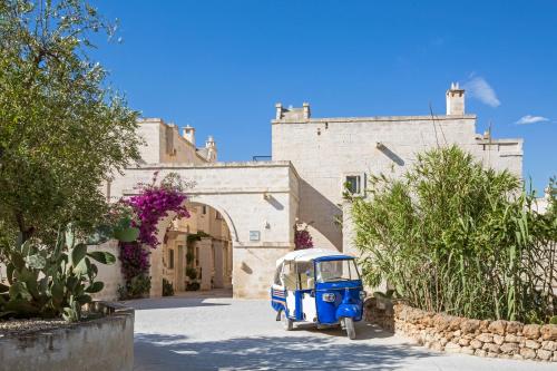 a blue vehicle parked in front of a building at Borgo Egnazia in Savelletri di Fasano