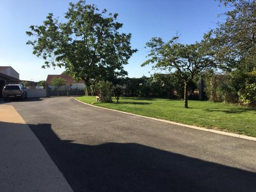 a shadow of a car on a road with trees at Maison d’izier in Izier