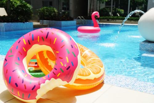 a pink donut float in a swimming pool at Dorsett Tsuen Wan, Hong Kong in Hong Kong