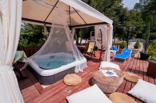 a hot tub in a gazebo on a deck at Krikonis Hotel in Ioannina