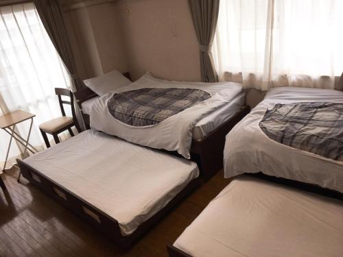 מיטה או מיטות בחדר ב-Hostel Mallika