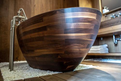a wooden bath tub sitting on top of a floor at Vinica Castle Boutique & Spa Hotel in Vinica