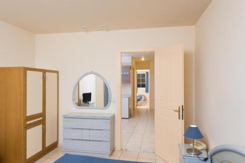 a bathroom with a sink, mirror, and cabinet at Creta Hotel in Agios Nikolaos