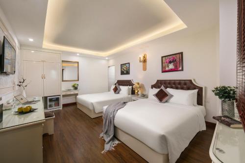 a hotel room with two beds and a kitchen at TrangTrang Boutique Hotel in Hanoi