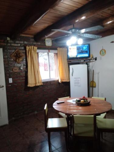 a dining room with a table and a tv at Cabañas Esferas de Cristal in Capilla del Monte