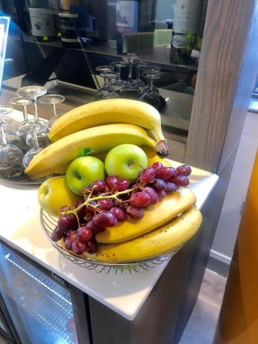 a bowl of bananas and grapes on a counter at Best Western Plus Vauxhall Hotel in London