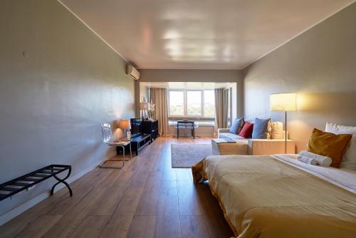 a bedroom with a bed and a living room at BEACHFRONT Cascais,Estoril Apartment in Estoril