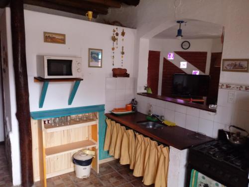 a kitchen with a sink and a counter top at Cabañas Esferas de Cristal in Capilla del Monte