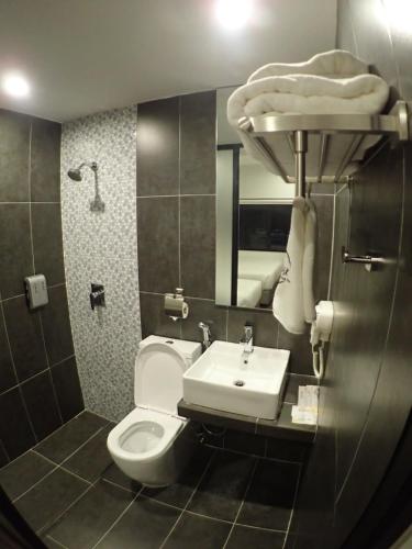 a bathroom with a toilet and a sink at Apex Boutique Hotel @ Bandar Sunway in Petaling Jaya