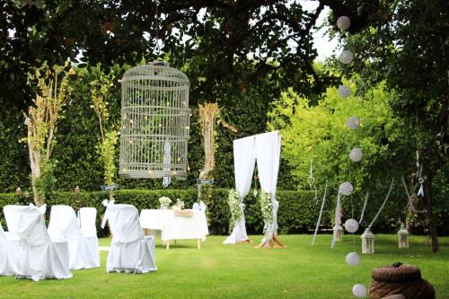 a table and chairs in a garden with a bird cage at Marigianna Apartments in Sissi