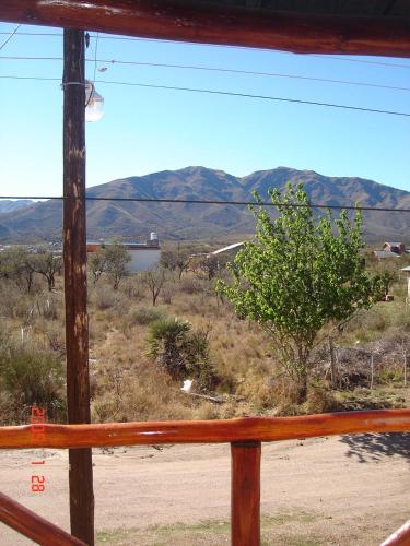 a view of a mountain range from a window at Cabañas Esferas de Cristal in Capilla del Monte