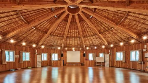 a large room with a large wooden ceiling at Healience Village in Hongcheon