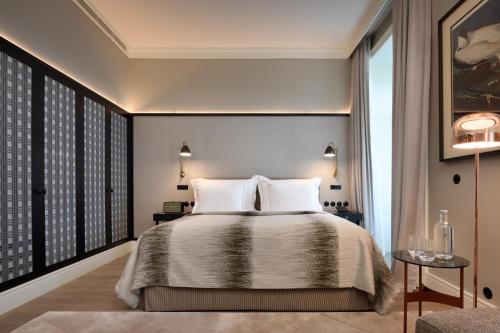 a bedroom with a bed and a large window at Bairro Alto Hotel in Lisbon