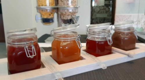 three jars of honey sitting on a tray at Hotel Rodon in Paralia Katerinis